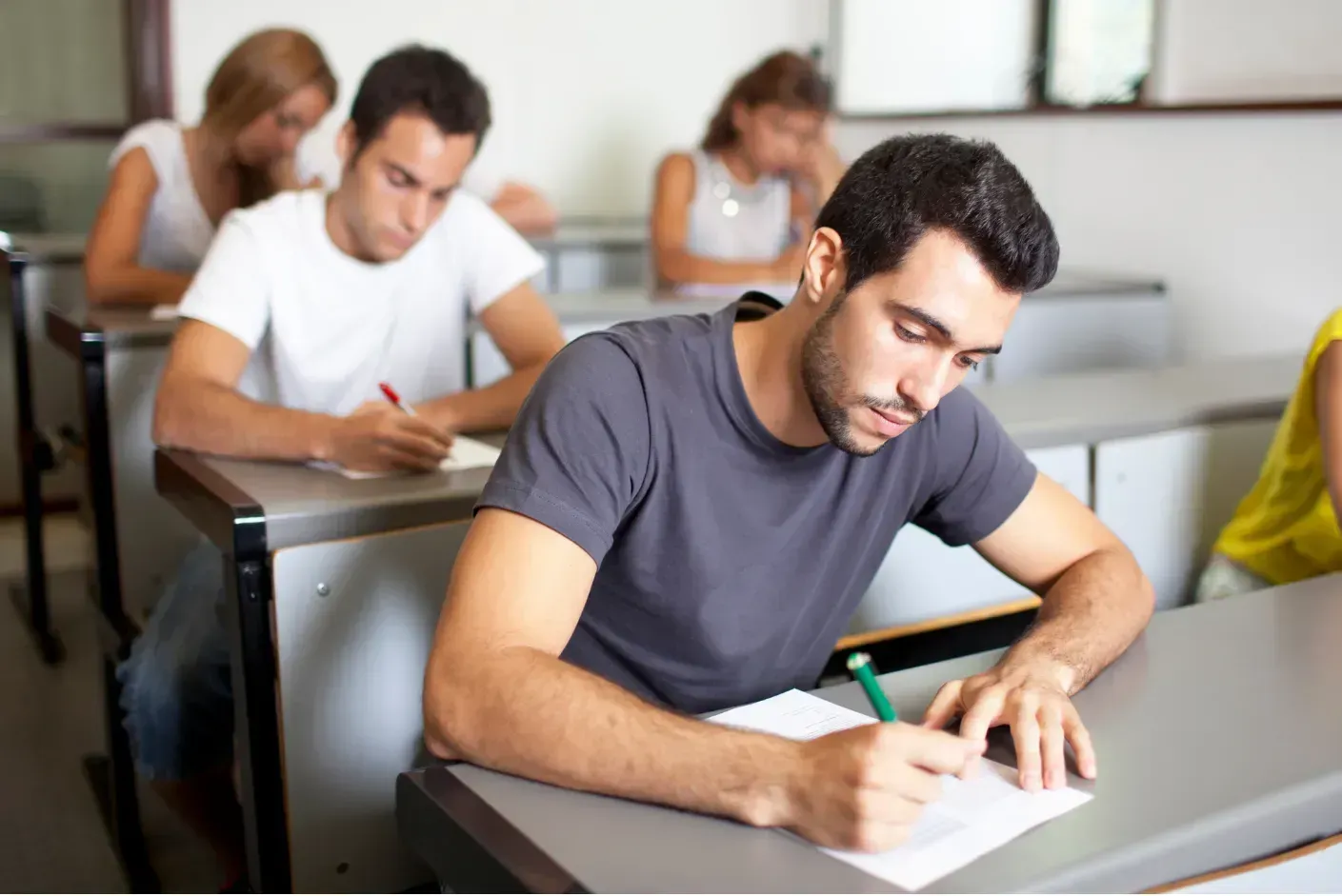 An open study guide and a laptop displaying Bloomberg Aptitude Test resources for efficient exam preparation.